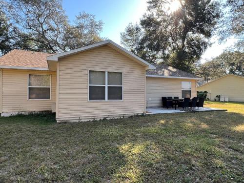 a house with a patio in a yard at Get cozy in this Renovated home by the Villages in Lady Lake