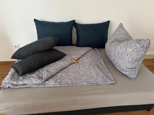 a bed with pillows and a blanket on it at Dorfwohnzimmer Apartment in Roggendorf