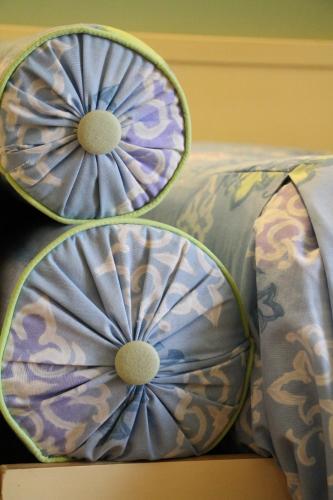 two pillows sitting on top of a bed at Hotel Matteotti in Vercelli