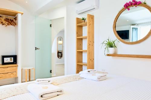 a bedroom with a bed with towels on it at Dream on Plaka in Plaka
