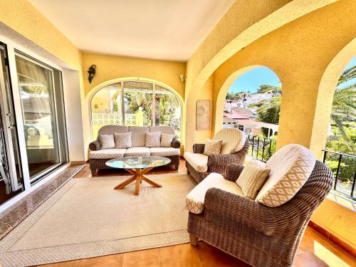 a living room with two chairs and a table at Casa Milana in Moraira