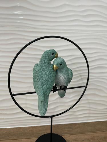 two birds sitting on top of a glass shelf at Un instant de pur bonheur in Moulins