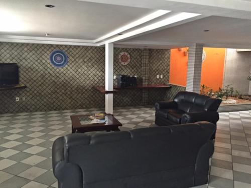 a living room with a couch and a table at Hotel Subaé in Feira de Santana
