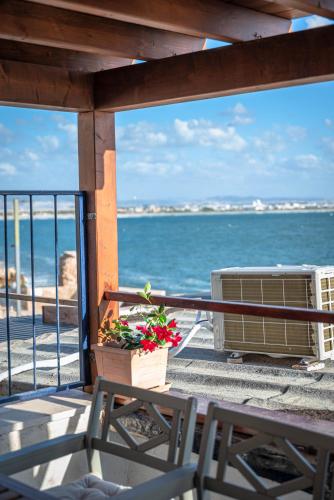 a balcony with a table and chairs and the ocean at Nov Antique - AKKO in ‘Akko
