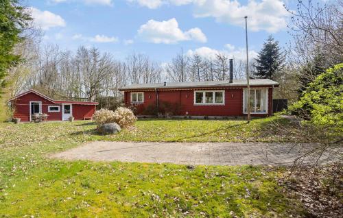 a red house in the middle of a yard at 3 Bedroom Stunning Home In Spøttrup in Spottrup