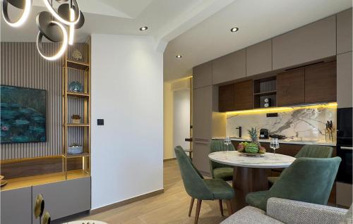 a dining room and kitchen with a table and chairs at Lovely Apartment In Korcula With Sauna in Korčula