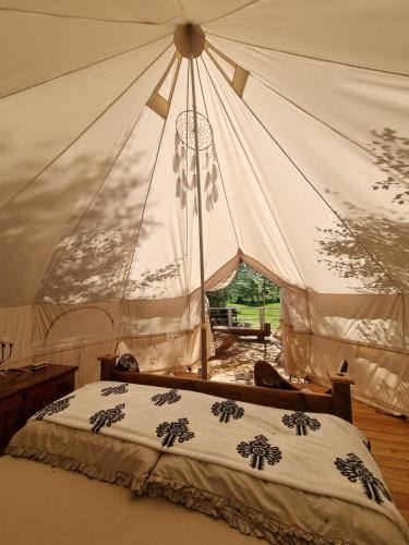 a bedroom with a bed with a tent at Glamping Štôla Brezovy vanok in Vyšné Hágy