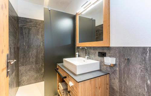 a bathroom with a sink and a mirror at Ferienhaus Großarl Mit Sauna in Grossarl