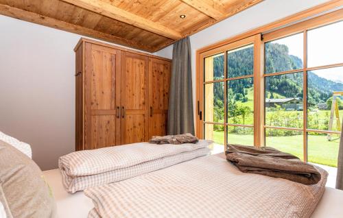 two beds in a room with a window at Ferienhaus Großarl Mit Sauna in Grossarl