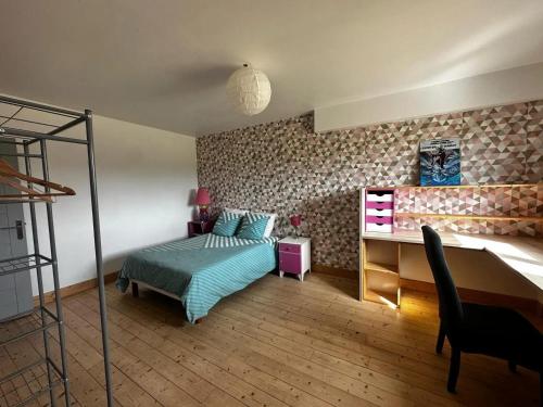 a bedroom with a bed and a desk at Appartement spacieux à Saint-Pierre-du-Mont 200 m² avec jardin in Saint-Pierre-du-Mont