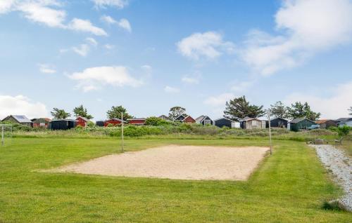 a baseball field with houses in the background at Amazing Home In Vestervig With Sauna in Vestervig