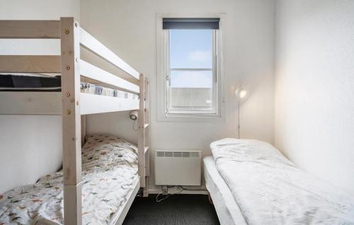 a bedroom with two bunk beds and a window at Amazing Home In Vestervig With Sauna in Vestervig