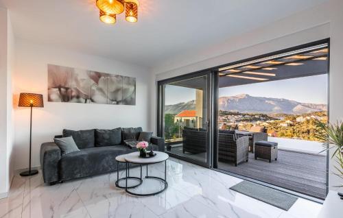 a living room with a couch and a large window at Beautiful Home In Lumbarda in Lumbarda