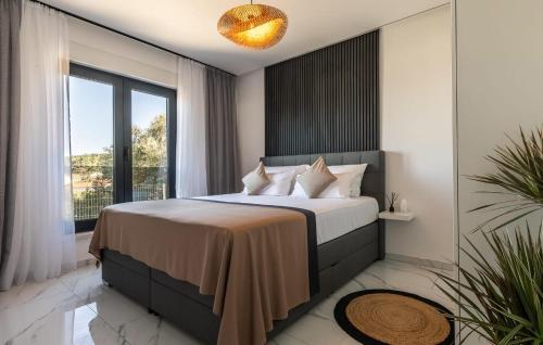 a bedroom with a large bed and a large window at Beautiful Home In Lumbarda in Lumbarda