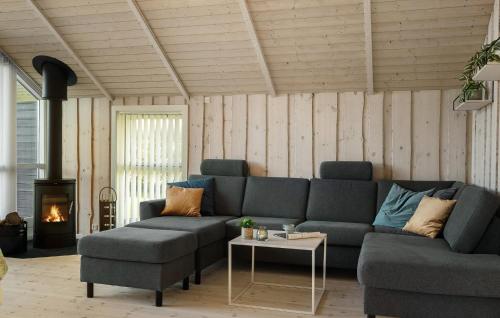 a living room with a couch and a table and a fireplace at Gorgeous Home In Vinderup With Sauna in Vinderup