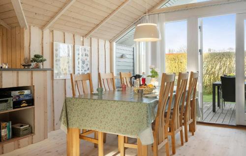 a kitchen and dining room with a table and chairs at Gorgeous Home In Vinderup With Sauna in Vinderup