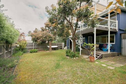 a house with a yard in front of it at The Blue House - 200m from Point Roadknight Beach in Anglesea