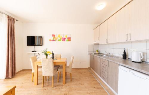 a kitchen and dining room with a table and chairs at Gorgeous Apartment In Duce With Wifi in Duće
