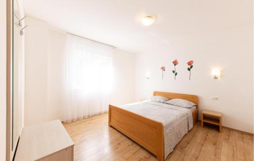 a white bedroom with a bed and a window at Gorgeous Apartment In Duce With Wifi in Duće