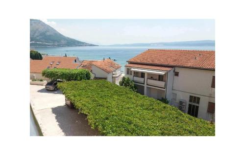 a view of a house with the ocean in the background at Gorgeous Apartment In Duce With Wifi in Duće