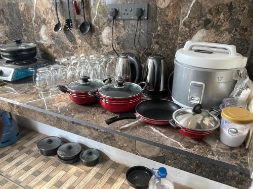 a kitchen counter with pots and pans on it at Royal Palace Mirissa in Mirissa