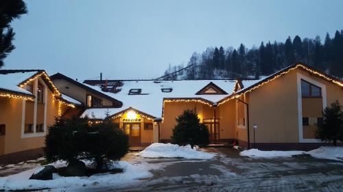 a row of houses with christmas lights on them at Penzion Jantoľák in Zuberec