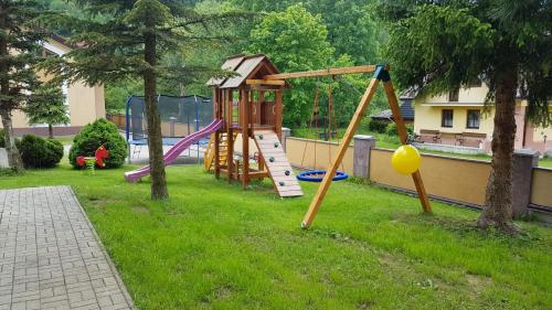 a park with a playground with a slide at Penzion Jantoľák in Zuberec
