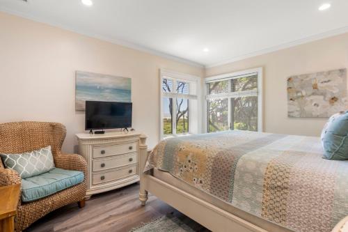 Un dormitorio con una cama, un televisor y una silla. en 4416 Windswept Villa by Akers Ellis Rentals, en Kiawah Island