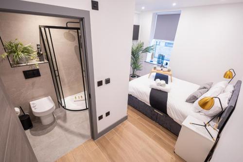 a small bedroom with a bed and a shower at Chic 2King BD Apt London with Ensuite & Pull Out Bed in Finchley