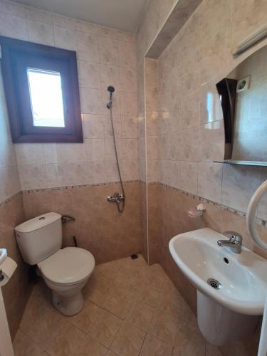a bathroom with a toilet and a sink at Aseva House Guest house in Bansko