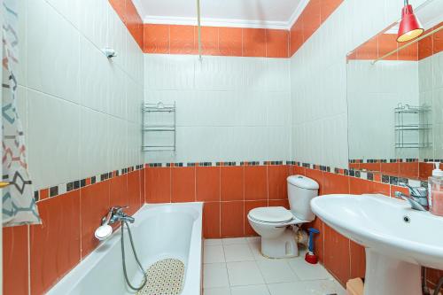 a bathroom with a tub and a toilet and a sink at Villa on Red Sea in Hurghada