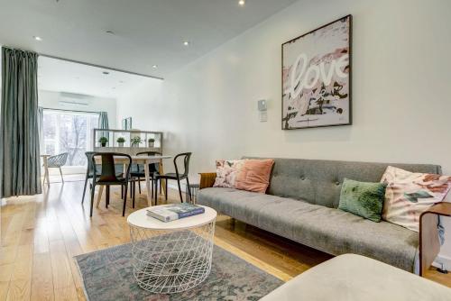 a living room with a couch and a table at Private & Exclusive Stay Near Montreal's Nightlife in Montréal