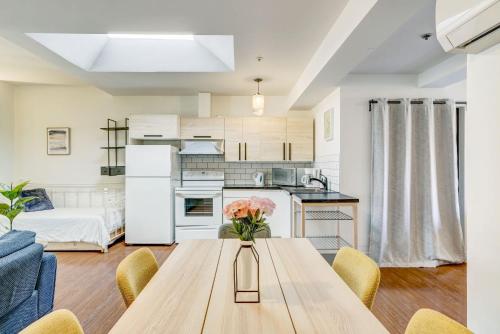 a kitchen and living room with a table with flowers at Private & Exclusive Stay Near Montreal's Nightlife in Montréal