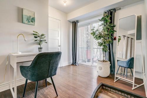 a living room with a desk and chairs and a window at Private & Exclusive Stay Near Montreal's Nightlife in Montréal