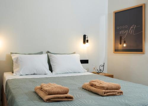 two towels sitting on top of a bed at Mint Serenity Heraklio near InterClinic in Thérissos