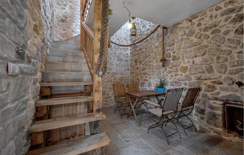 a staircase in a room with a table and chairs at 2 Bedroom Amazing Home In Pirovac in Pirovac