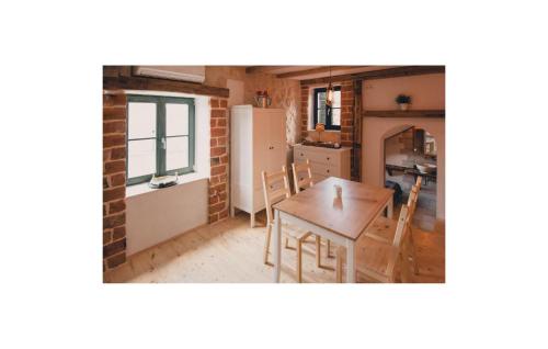 a kitchen with a table and a refrigerator at 2 Bedroom Amazing Home In Pirovac in Pirovac