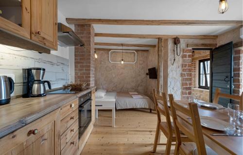a kitchen with a table and chairs and a bedroom at 2 Bedroom Amazing Home In Pirovac in Pirovac