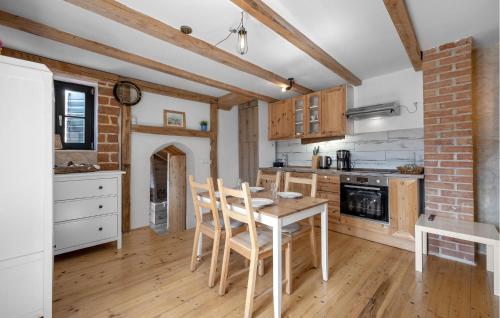 a kitchen with a table and chairs in a room at 2 Bedroom Amazing Home In Pirovac in Pirovac