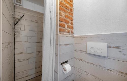 a bathroom with a roll of toilet paper on the wall at 2 Bedroom Amazing Home In Pirovac in Pirovac