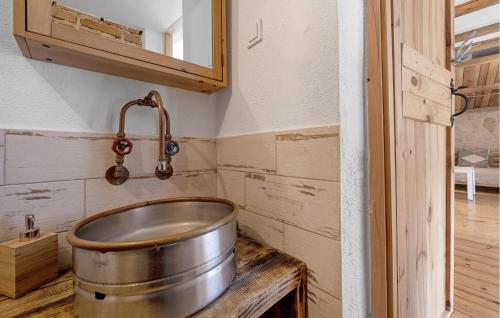 a large metal tub in a kitchen with a tap at 2 Bedroom Amazing Home In Pirovac in Pirovac