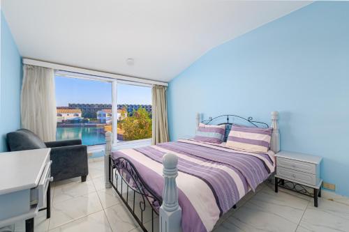 a bedroom with a bed and a large window at Villa on Red Sea in Hurghada