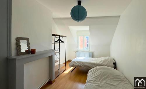 a room with two beds and a mirror in it at Villa Les Pieds dans l'Eau - 4chambres 10personnes - Central & Proche Mer in Le Portel