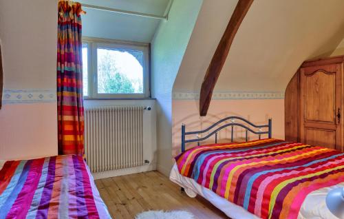 a bedroom with a bed and a window at Aut Longère Vue Campagne in Beauficel