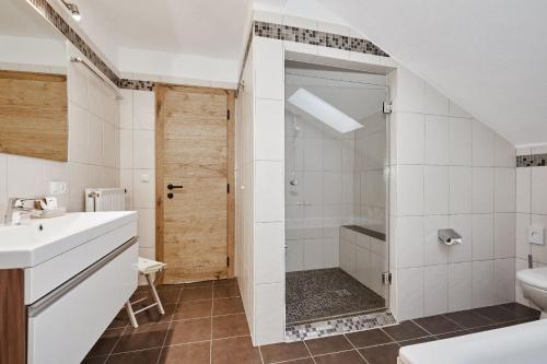 a bathroom with a shower and a sink at Ferienwohnung MOOS 2 mit Wellnessnutzung in Ainring