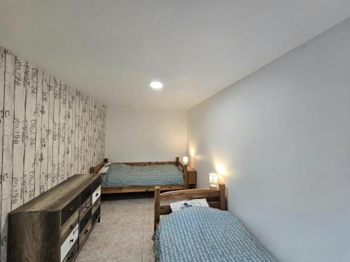 a bedroom with two twin beds and a wall mural at Les demoiselles de grignols in Grignols Dordogne