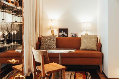 a living room with a couch and a table at Hotel SAX Paris, LXR Hotels & Resorts in Paris