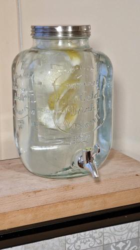 a glass jar sitting on top of a wooden shelf at Hostal Remoña in Espinama
