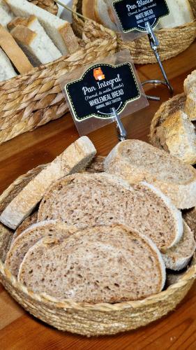 a group of breads in baskets on a table at Hostal Remoña in Espinama