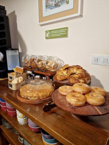 a table topped with lots of different types of pastries at Hostal Remoña in Espinama